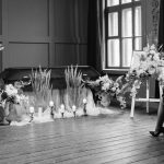 A somber funeral scene in grayscale showing a pastor and woman mourning.
