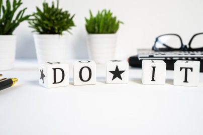 Inspiring office scene with 'Do It' blocks and plants, perfect for motivation.